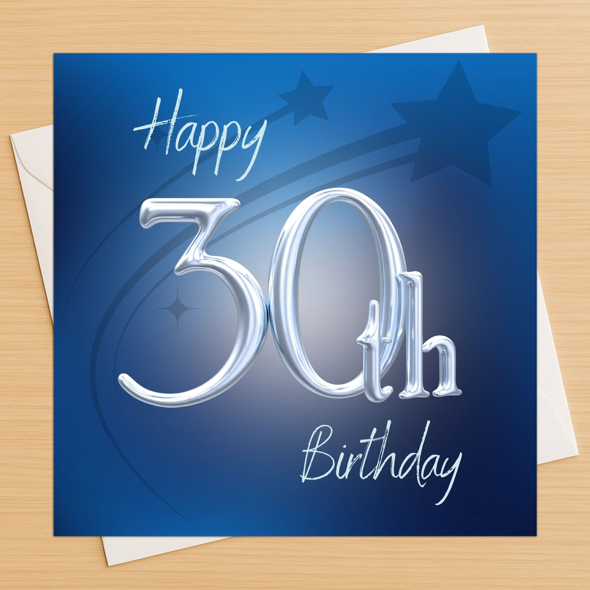 Blue birthday card with 'Happy 30th Birthday' text on a wooden surface