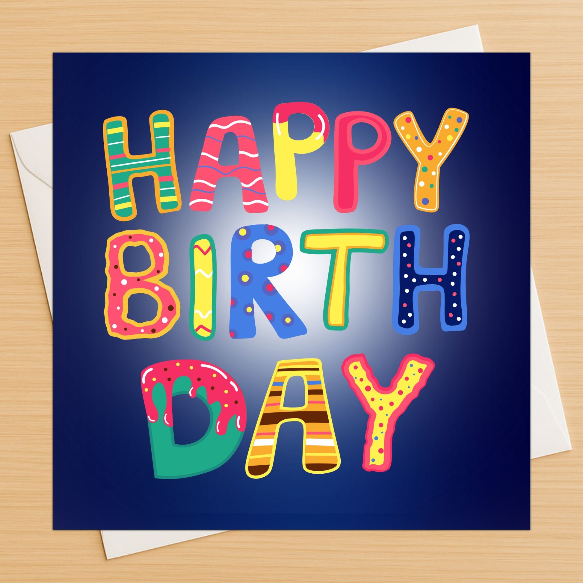 Colourful letters happy birthday card with bold playful text on wooden table
