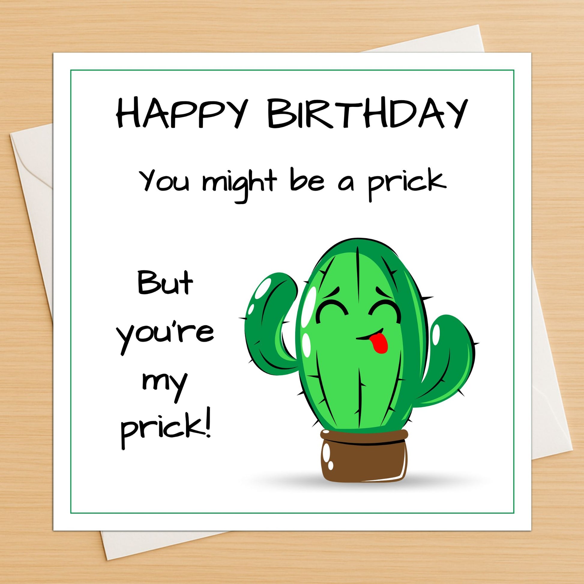 Funny cactus prick birthday card lying flat on a wooden table with white envelope