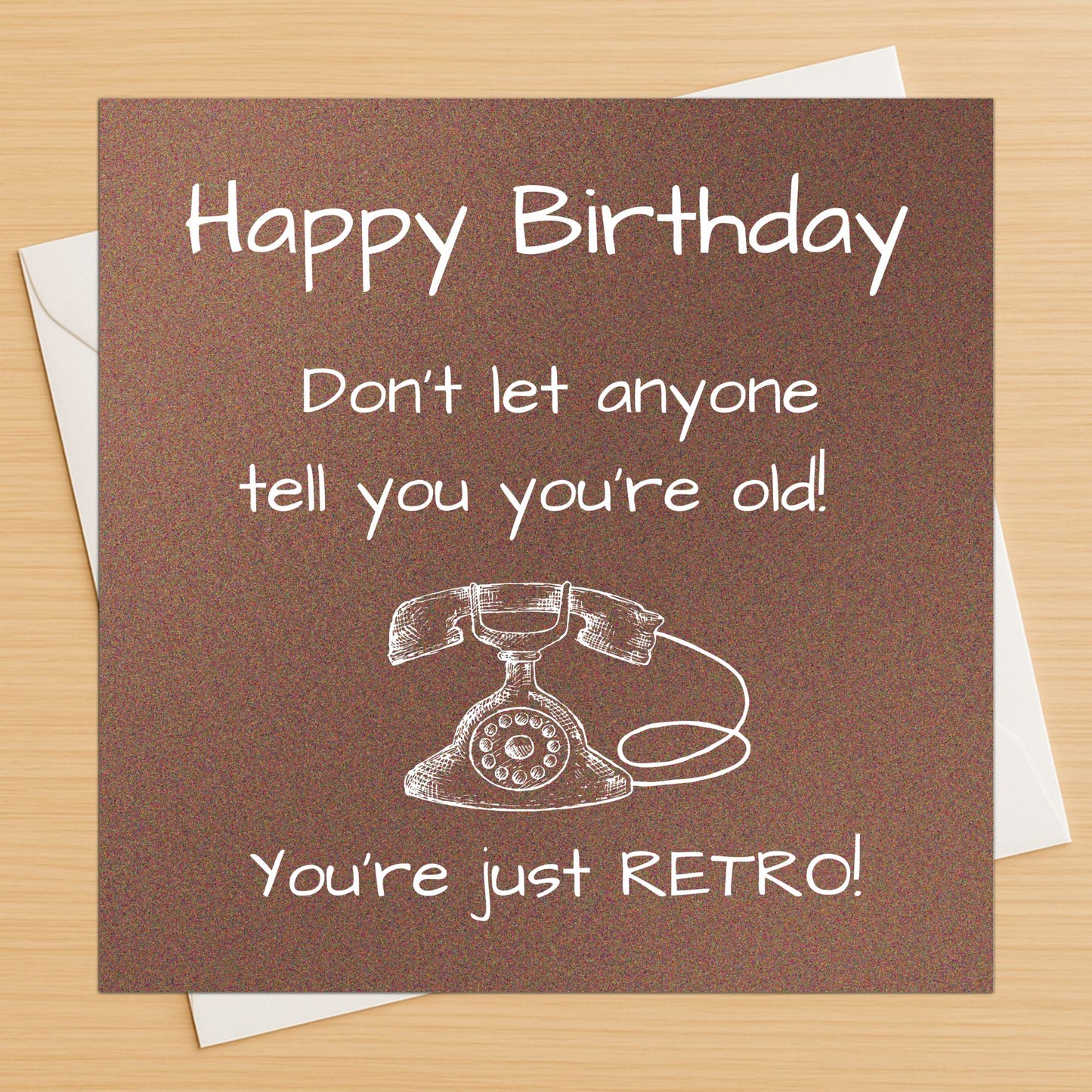 Birthday card with vintage phone illustration and humorous text on a brown background