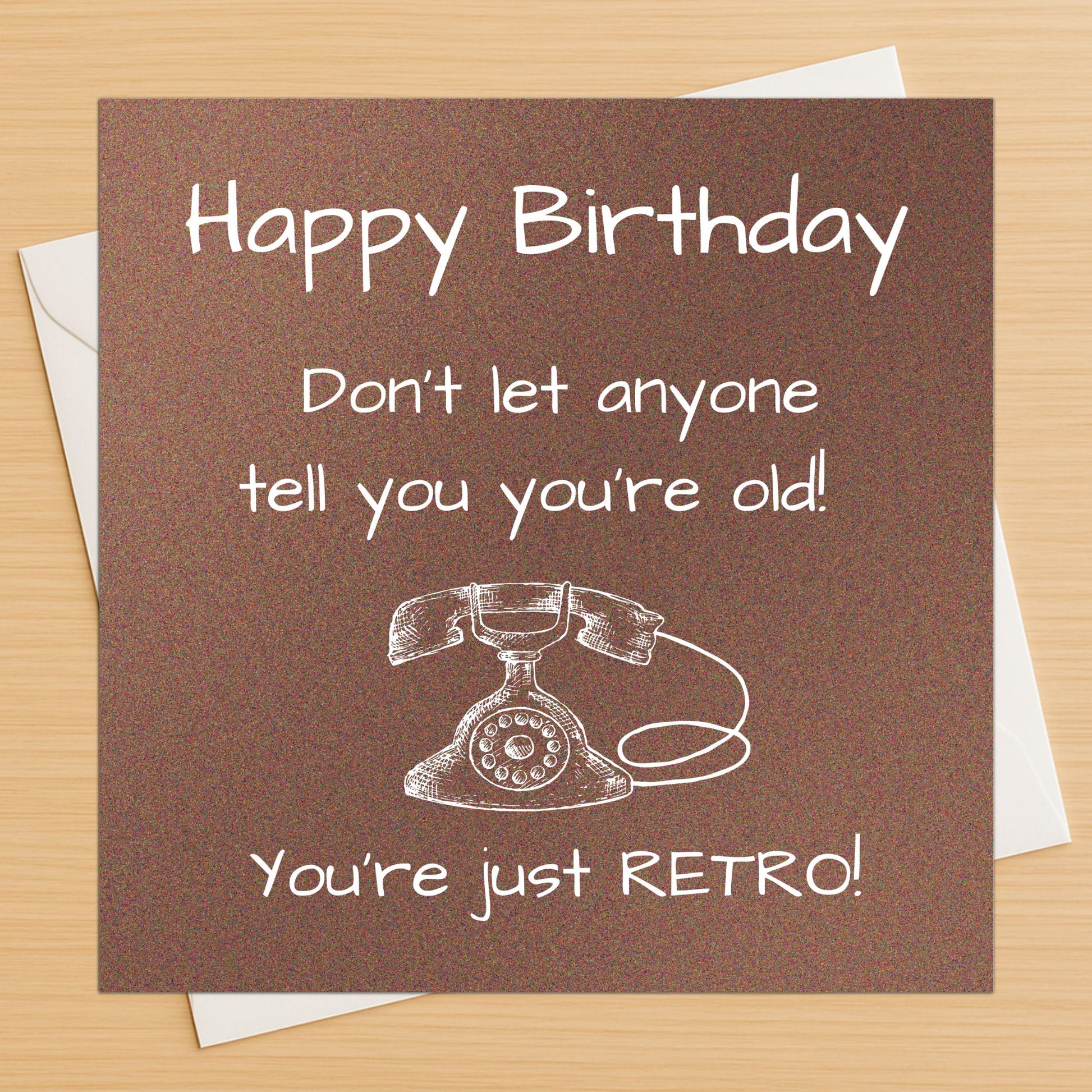 Birthday card with vintage phone illustration and humorous text on a brown background