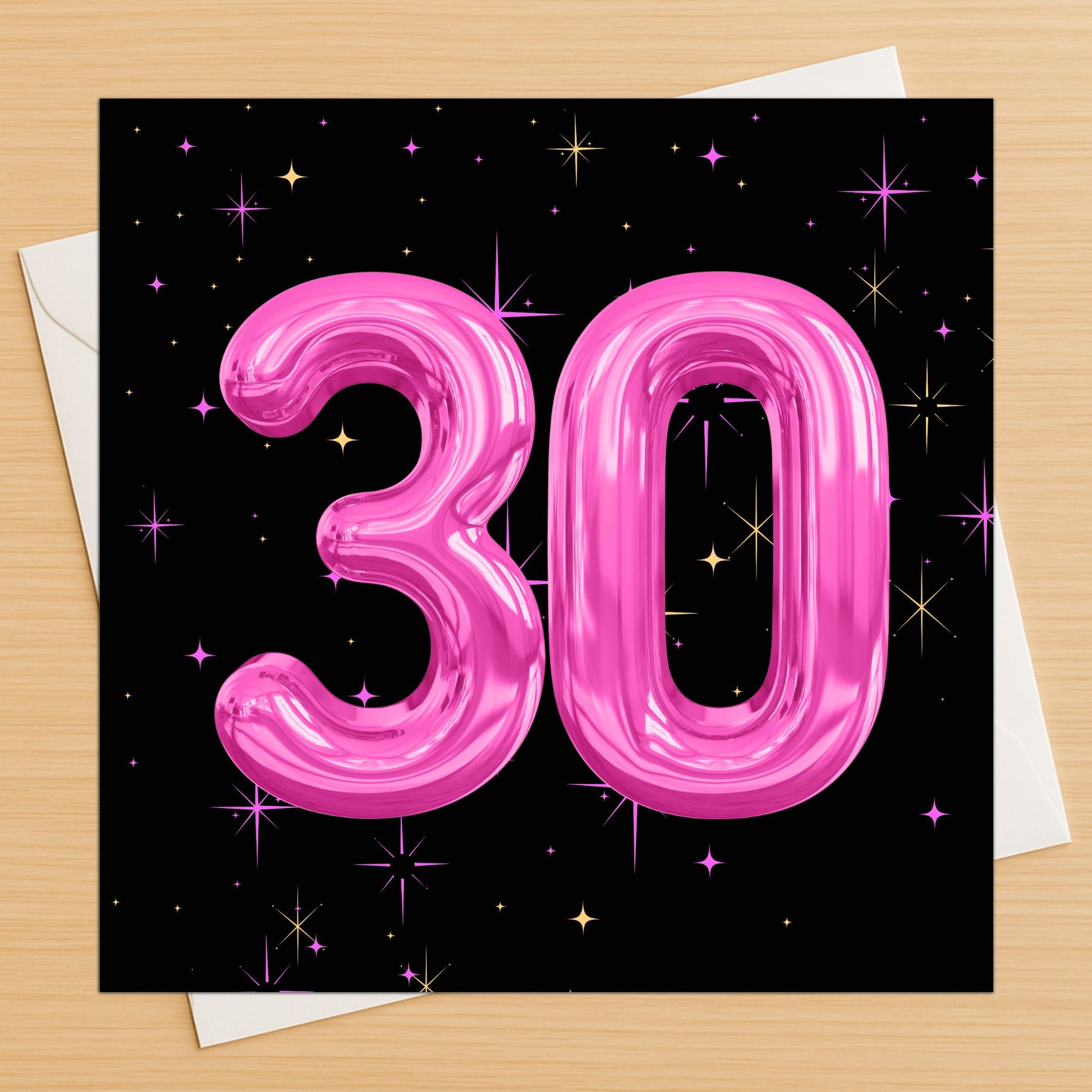 Pink number '30' balloon design on a black background with stars, on a wooden surface.