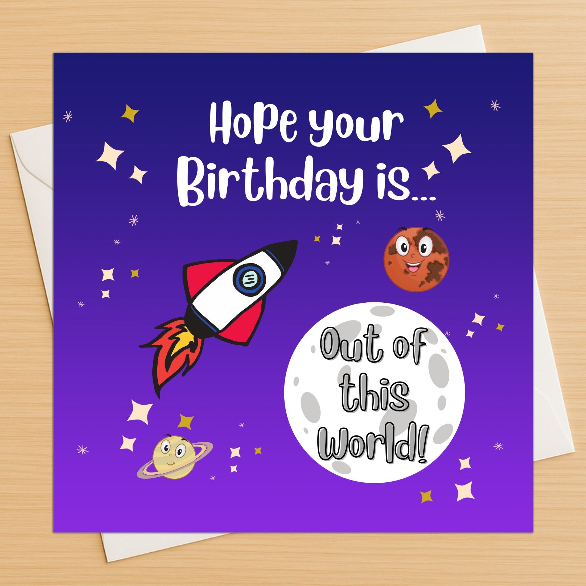 Space rocket out of this world birthday card with planets and stars on wooden table
